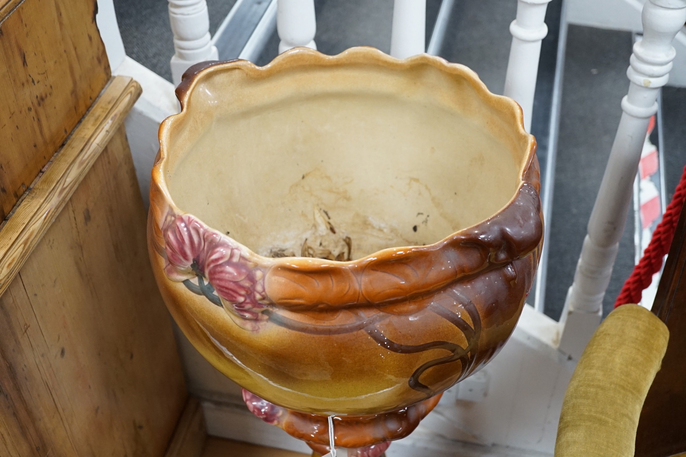An Art Nouveau style earthenware jardiniere on pedestal. 93cm tall